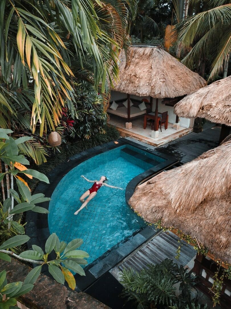 woman soaking on the swimming pool - Quotes for Travel in Spring 