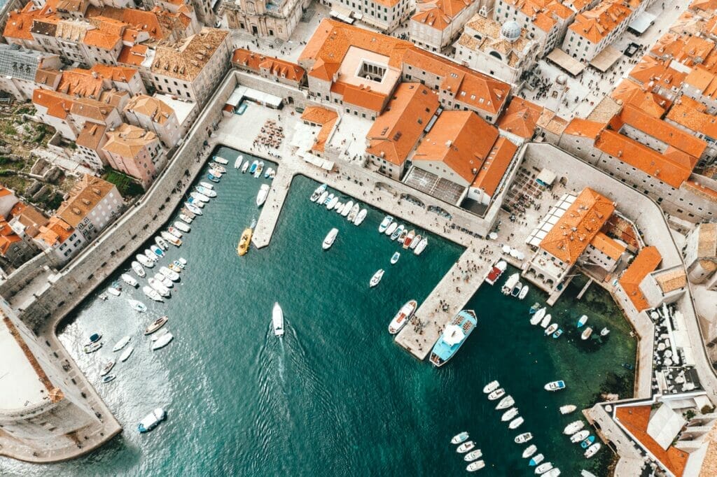 old city port with moored ships and historical houses - Drone view of Dubrovnik Croatia Port