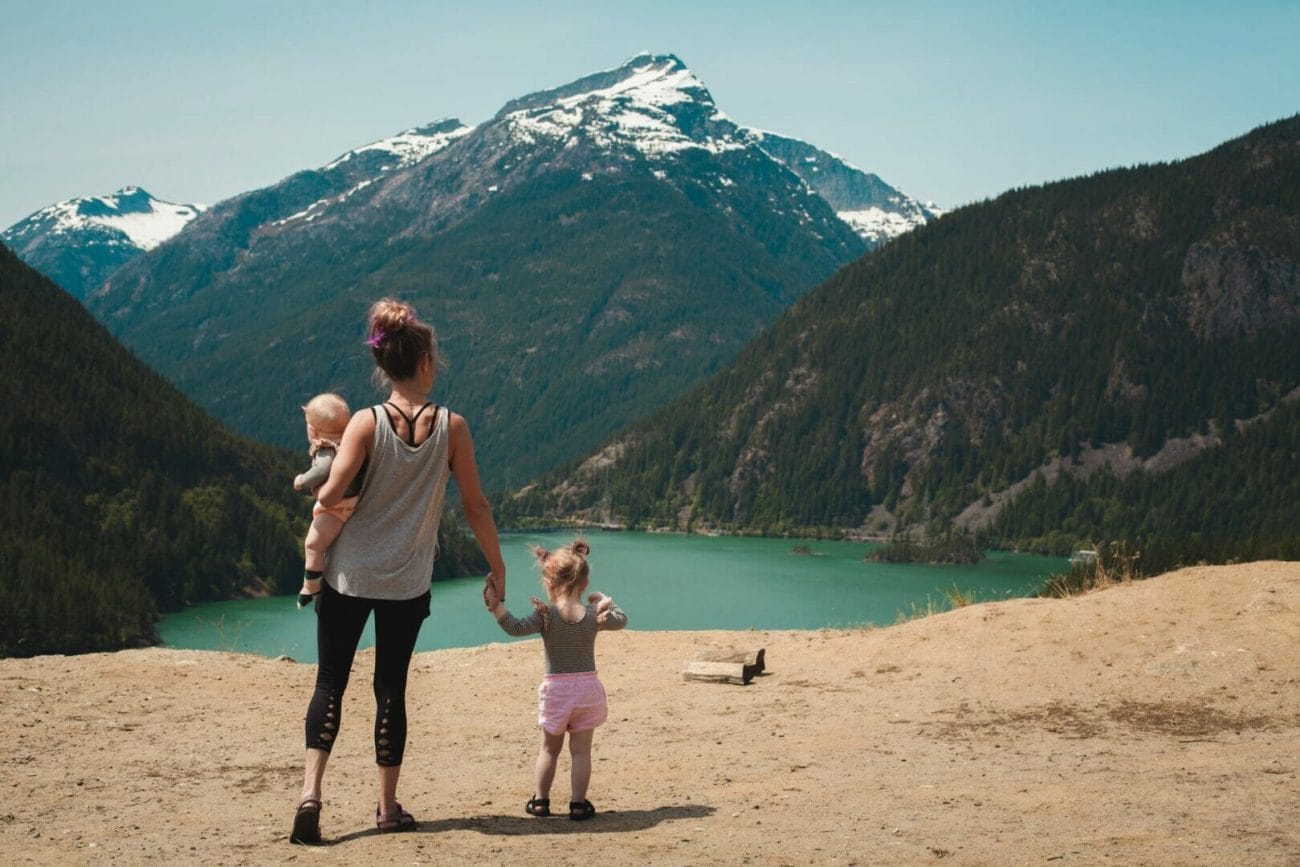 mother and children walks near body of water - Vacation Instagram Captions
