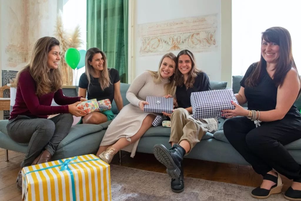 women with presents sitting on a couch