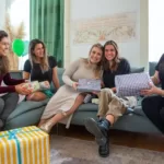 women with presents sitting on a couch
