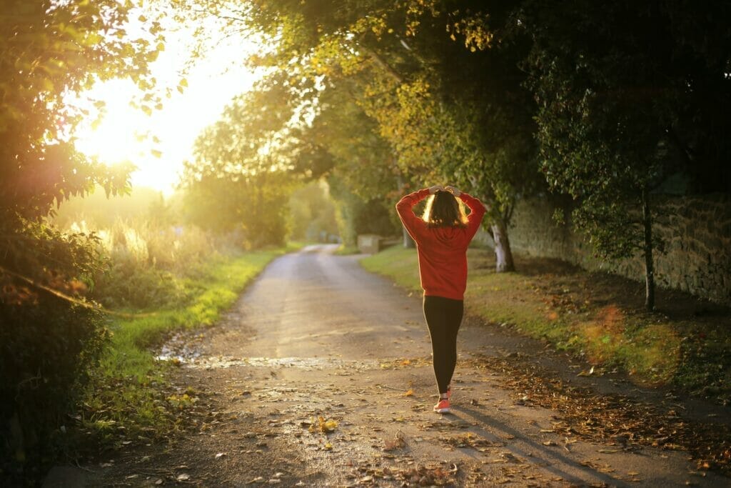 woman walking on pathway during daytime - International Travel Documents