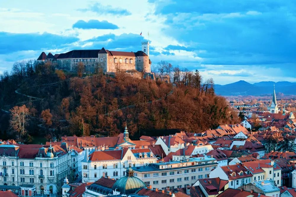 Travelers can visit a picturesque castle nestled atop a hill in Ljubljana, Slovenia.