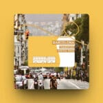 A yellow book showcasing public transport in Barcelona with a picture of the city on its cover.