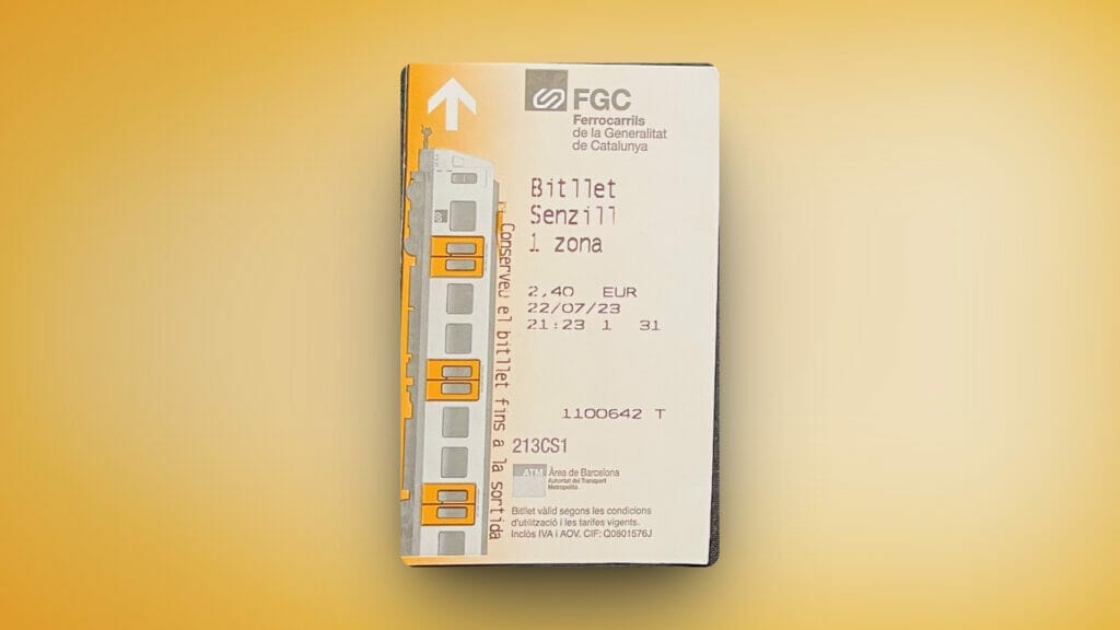 A Barcelona train ticket on a yellow background.