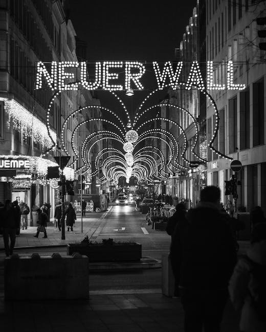 A black and white photo of people walking down a street with a sign that says never wall.