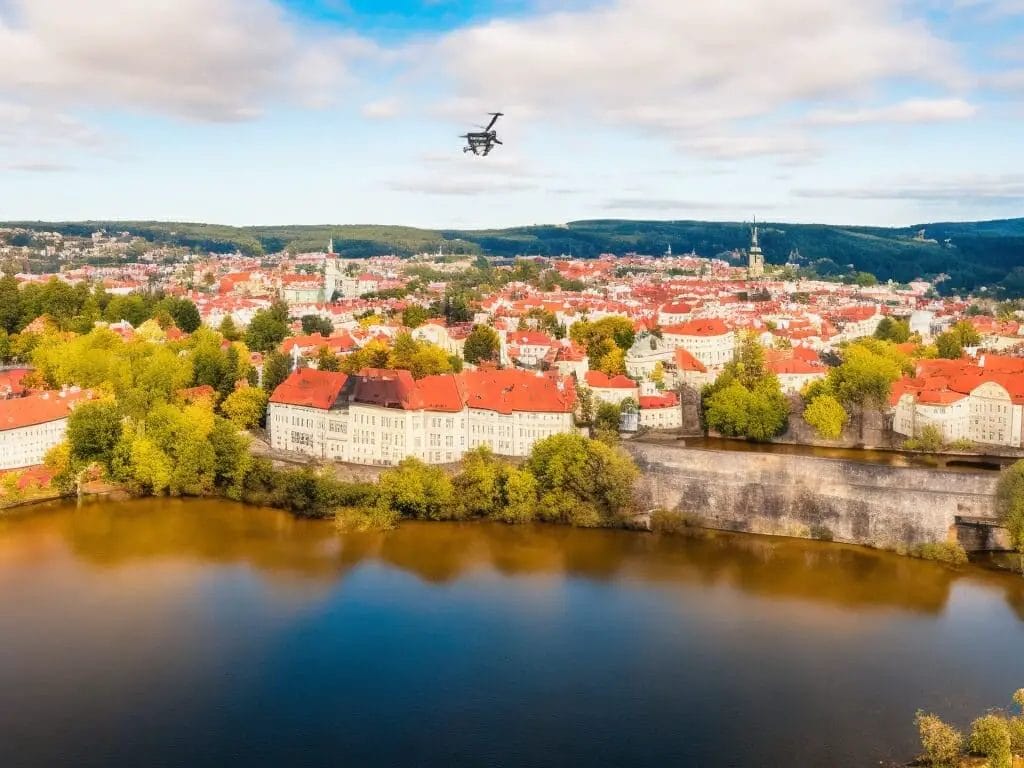 Drone Laws in Czech Republic : A drone flies over a town with a river in the background, following Czech Republic laws.