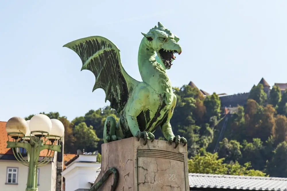 A magnificent dragon statue perched atop a bridge in Slovenia, worth visiting. 10 Reasons Why Slovenia is Worth Visiting for your next trip
