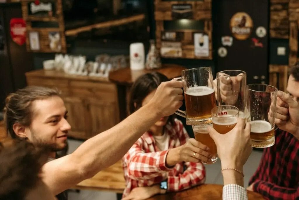 A group of friends drinking beer at a bar.