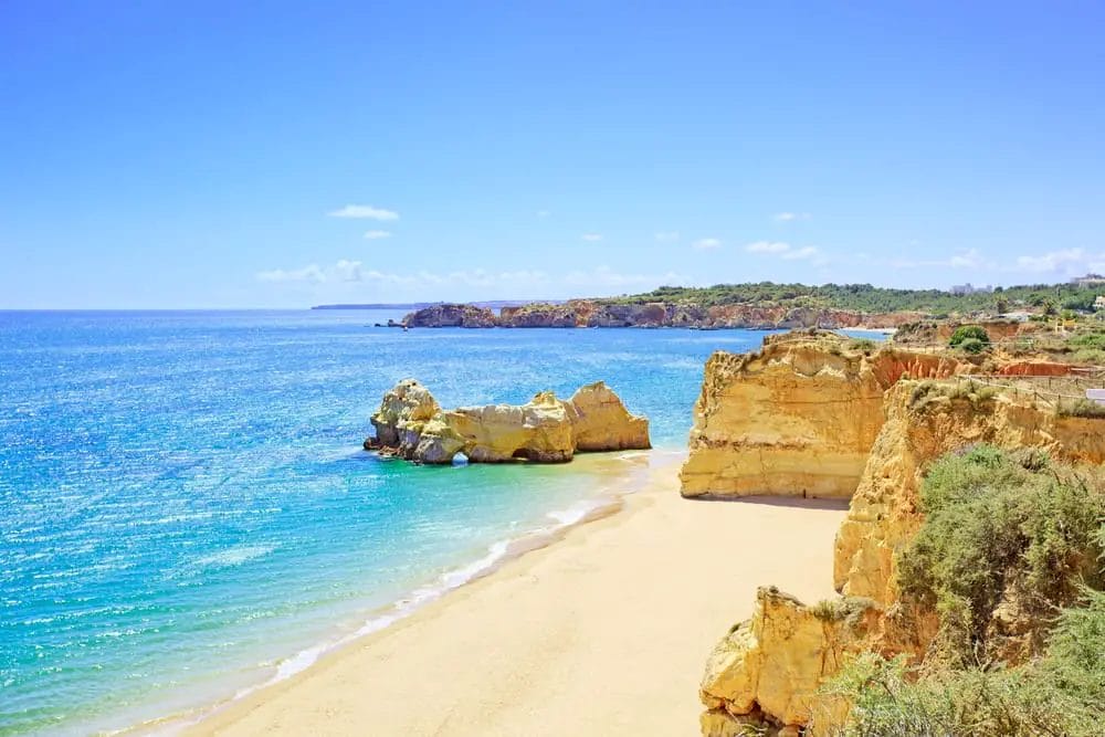 One of the best sandy beaches in Europe, with cliffs and a blue sky.