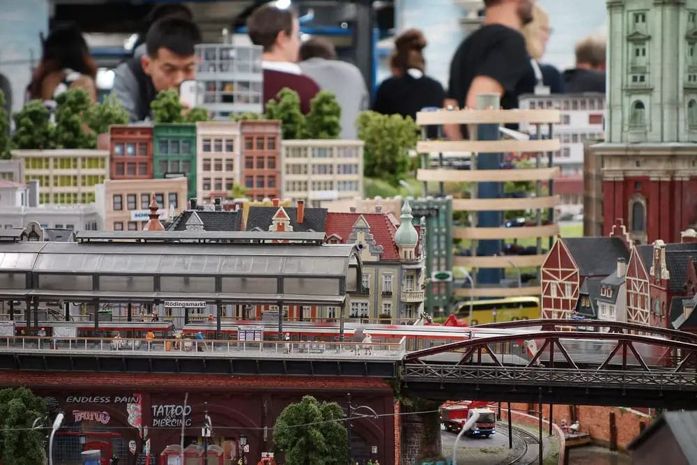 Visitors exploring a model of Hamburg, Germany.
