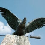 A statue of a bird with wings spread.