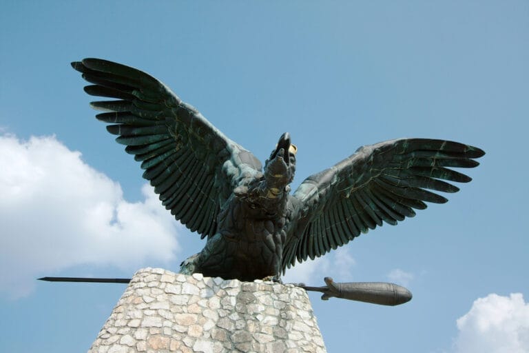 A statue of a bird with wings spread.