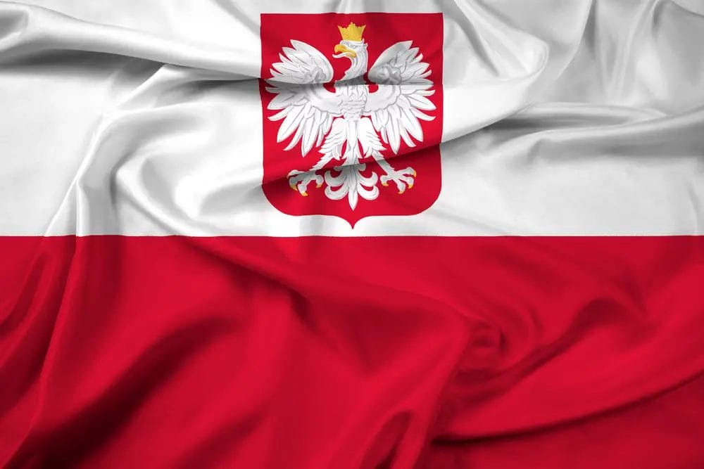 The flag of Poland, representing the national identity, proudly flutters in the wind. - National Animal of Poland