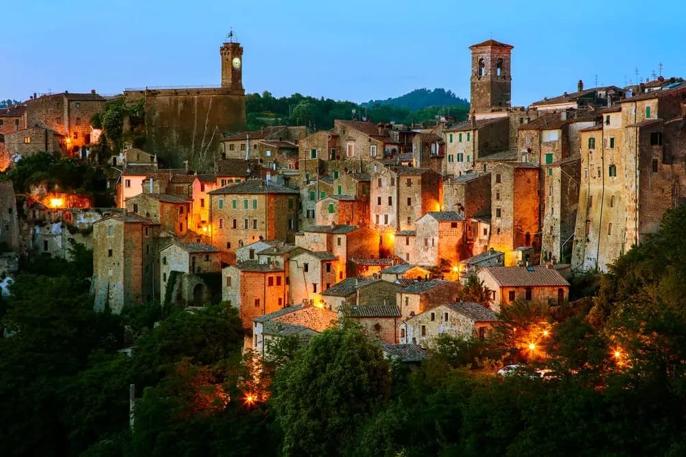 A serene small town in Italy at dusk, ideal for ecotourism enthusiasts looking to immerse themselves in the beauty of nature.