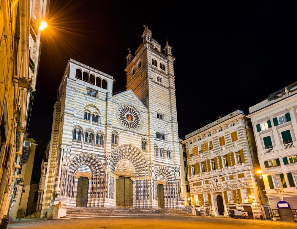 One day in Genoa, a grand building stands tall with a clock tower.