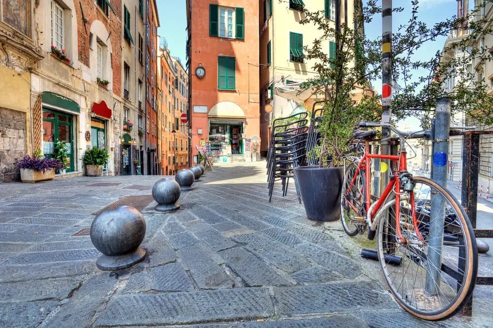One day in Genoa, a bicycle is parked on a cobblestone street.