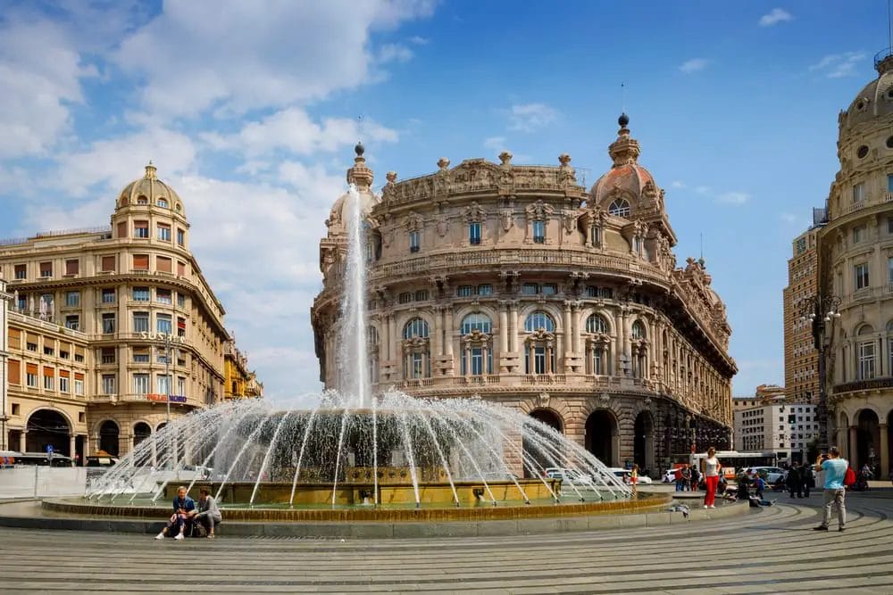 One day in Genoa, a fountain stands in the middle of a square.