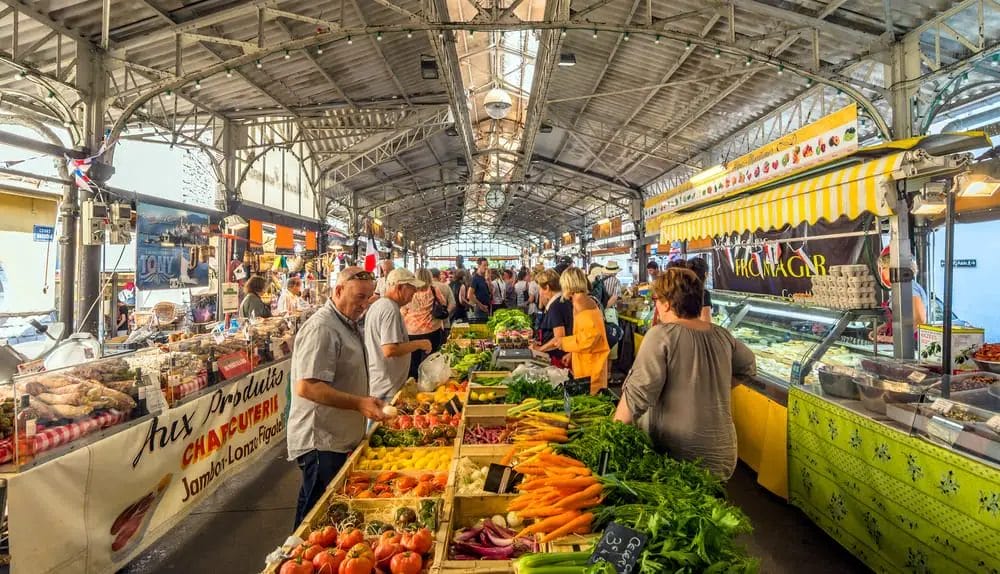 Visit the bustling indoor market in Antibes filled with an abundance of fresh produce.