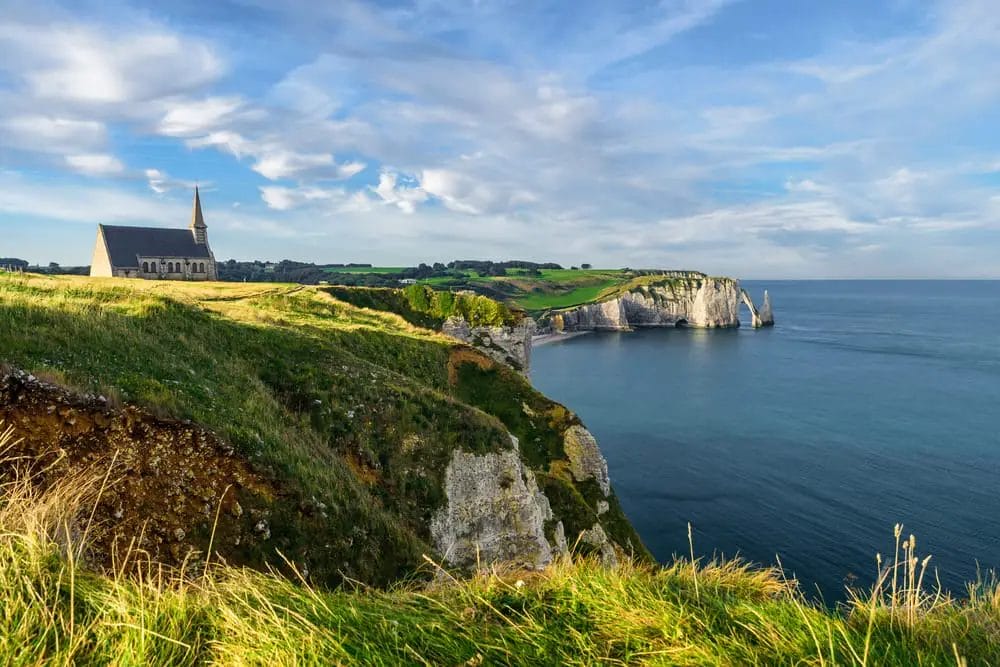 A cliff overlooking the ocean, one of the breathtaking places to visit in Normandy.