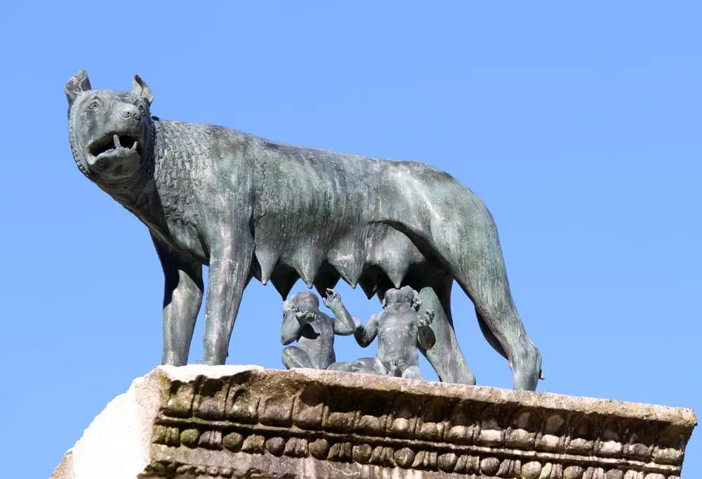 A statue of a wolf feeding babies.