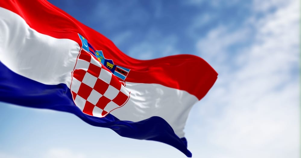 The flag of Croatia is flying in the sky.